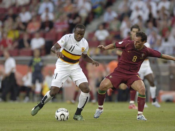 BT Sport. Football. FIFA World Cup. Cologne. 11th June 2006. Angola 0 v Portugal 1. Angola's Mateus, left, challenged by Portugal's Petit.